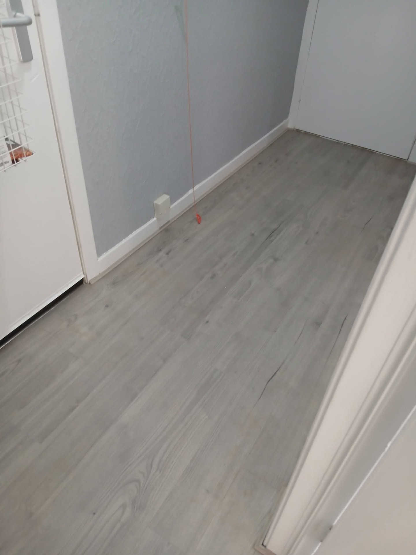 Grey laminate flooring fitted in a narrow Motherwell hallway
